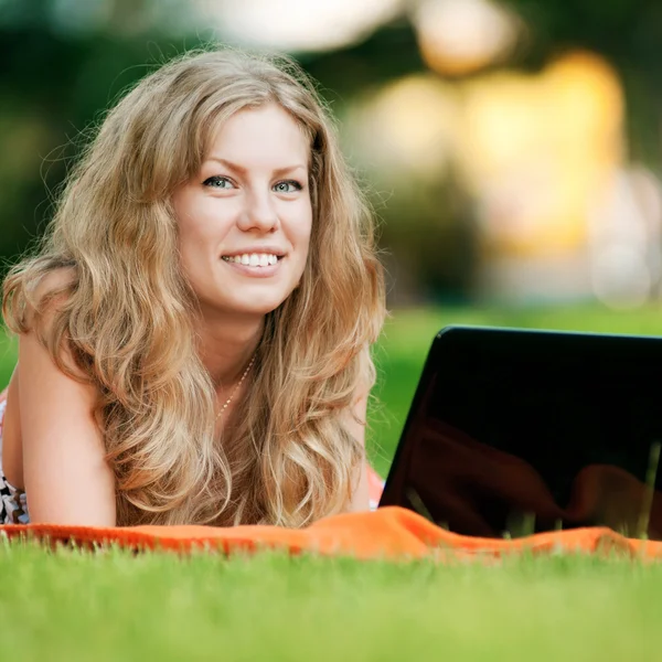 Jovem com laptop no parque — Fotografia de Stock