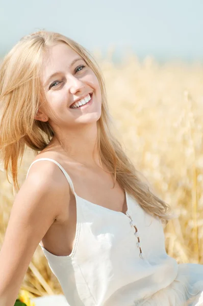 Buğday alanında piknik üzerinde mutlu bir kadın — Stok fotoğraf