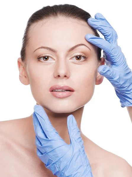 Beautician touch and exam health woman face Stock Picture