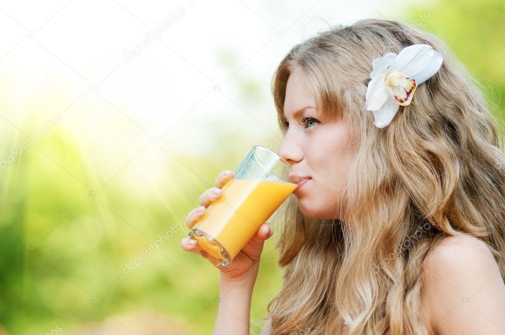 Smiling woman drinking orange juice