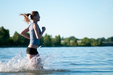 Sport woman running in water