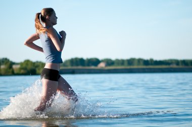 Sport woman running in water