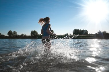 Sport woman running in water