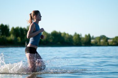 Sport woman running in water