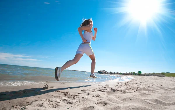 Sport woman running on beach — Stok fotoğraf