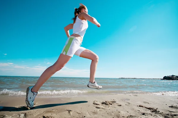 Deporte mujer corriendo en la costa del mar —  Fotos de Stock