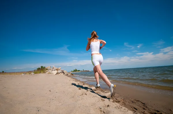 Sport woman running in sea coast — Stock Photo, Image