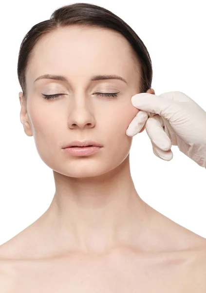 Beautician touch and exam health woman face. Stock Image