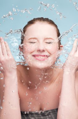 Portrait of beautiful emotional woman washing face clipart