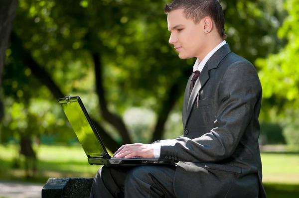Business man work on notebook at park. Student — Stock Photo, Image