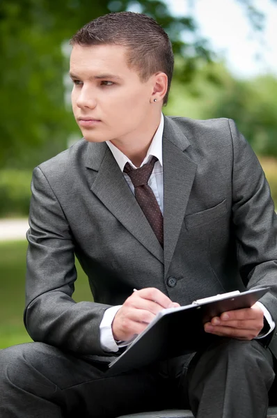 Business man working with papers at park. Student — Stock Photo, Image