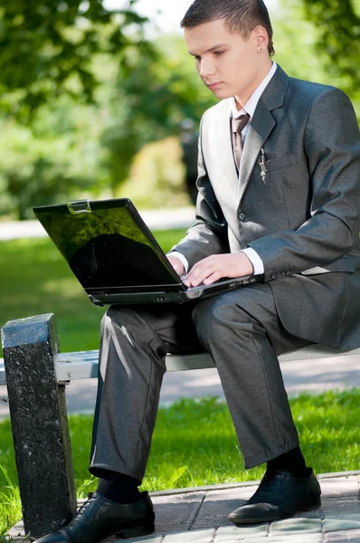 Un homme d'affaires travaille sur un carnet au parc. Étudiant — Photo
