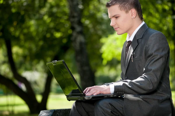 Business man work on notebook at park. Student — Stock Photo, Image