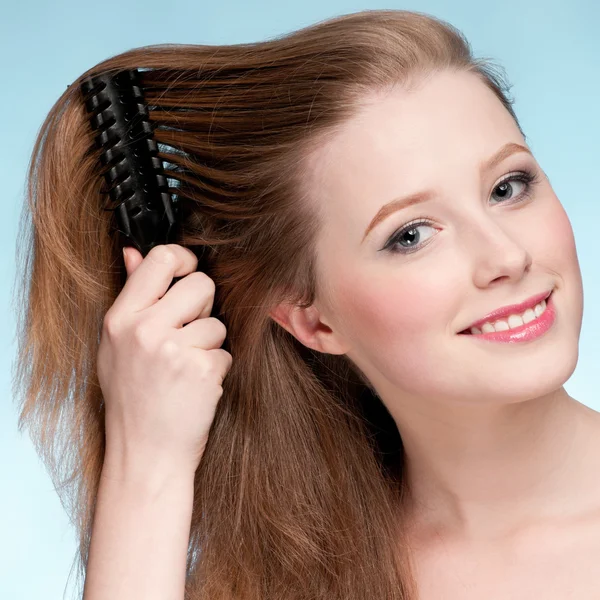 Close up portrait of young beautiful woman with comb — Stock Photo, Image