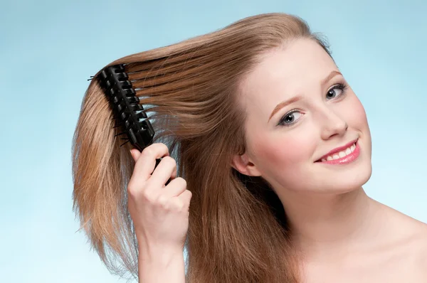Close up portrait of young beautiful woman with comb — Stock Photo, Image