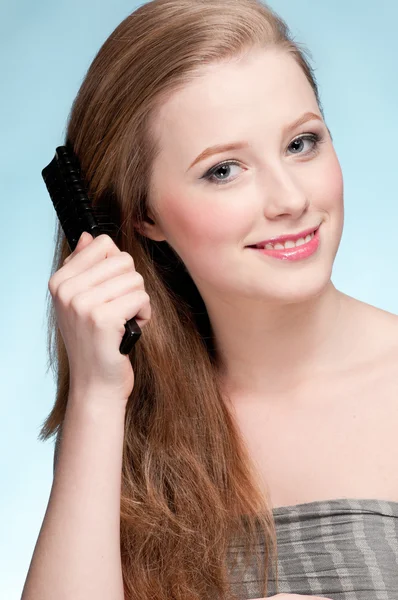 Close up portrait of young beautiful woman with comb — Stock Photo, Image