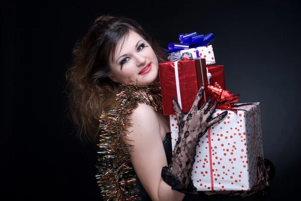 Stock image Closeup portrait of girl with red lips, tinsel and present on bl