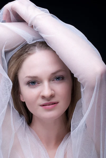 Closeup portrait of beautiful blond girl in white fabric — Stock Photo, Image