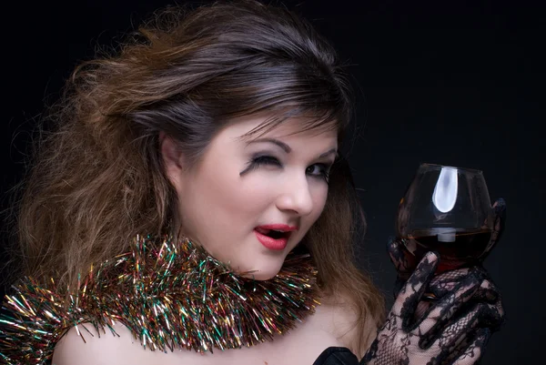 Closeup portrait of girl with red lips, tinsel and wineglass on — Stock Photo, Image