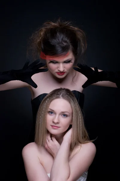 Closeup portrait of two girls: good & evil — Stock Photo, Image