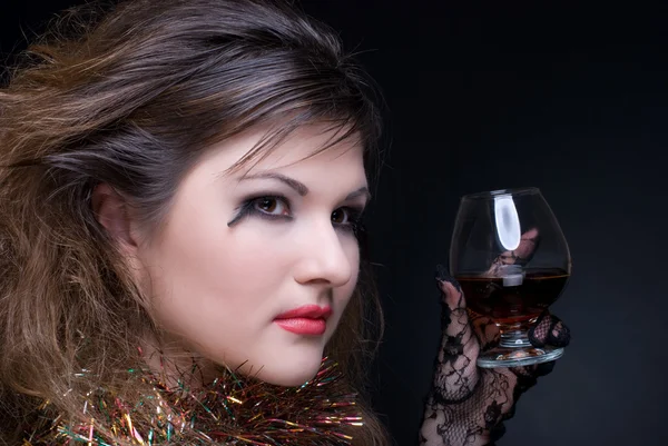 Closeup portrait of girl with red lips, tinsel and wineglass on — Stock Photo, Image