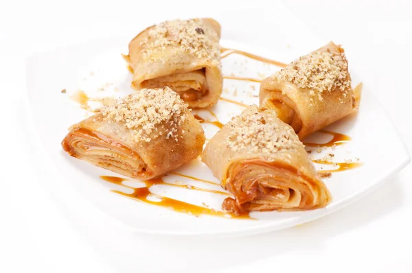 Rolled pancakes with caramel mousse — Stock Photo, Image