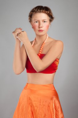 Young girl in an orange dress clipart