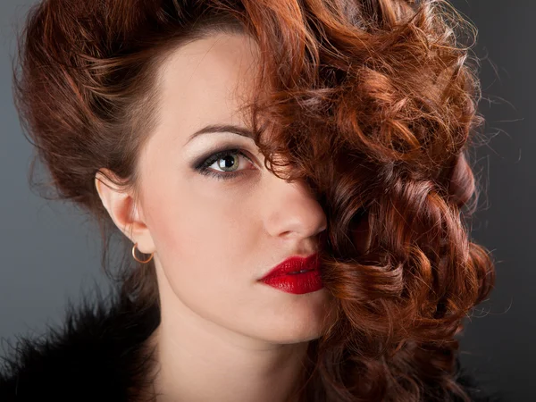 stock image Portrait of a curly red-haired girl with red lips