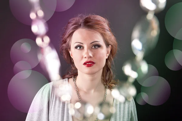 Portrait of a girl with red lips in a gray dress — Stock Photo, Image
