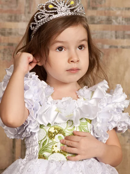 Little girl in white dress with a tiara on her head — Stock Photo, Image