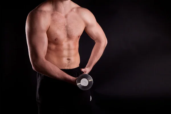 Muscular powerful man lifting metal weights — Stock Photo, Image