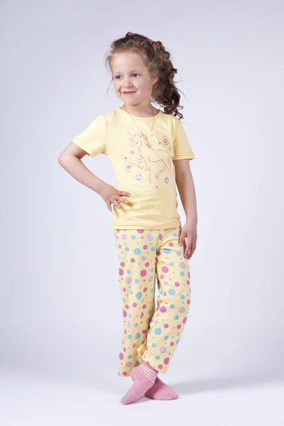 stock image Cute little girl in yellow pajamas