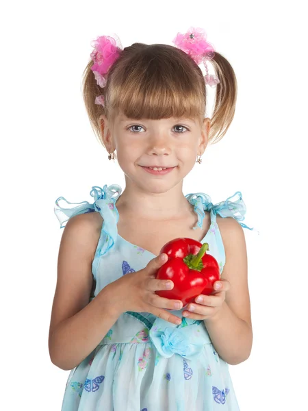 Una bambina dolce con un peperone rosso in mano — Foto Stock