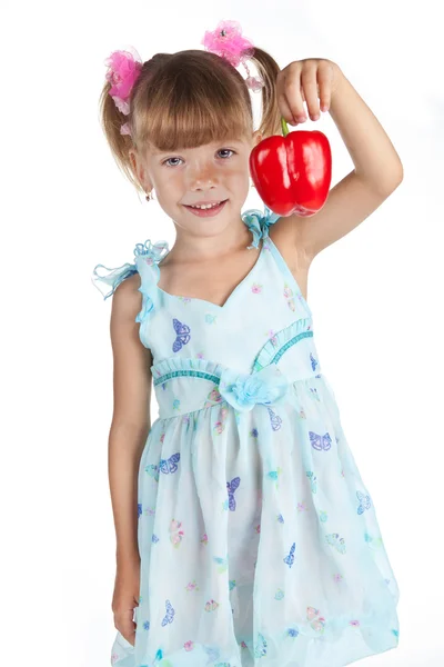 A little sweet girl with a red pepper in her hand — Stock Photo, Image