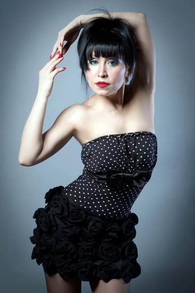 Portrait of a brunette woman in a polka dot dress — Stok fotoğraf
