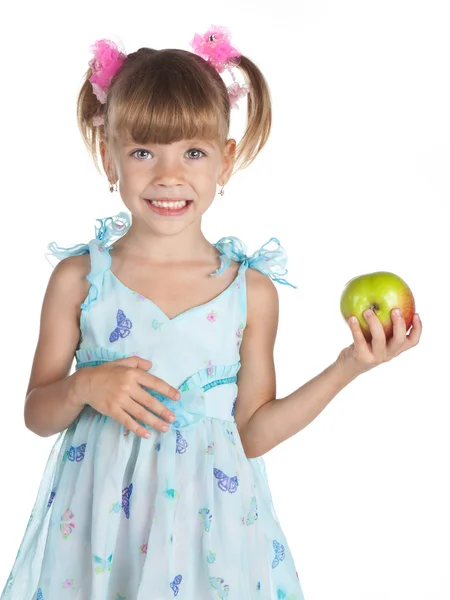Mooi meisje in een blauwe jurk met een appel in haar hand — Stockfoto