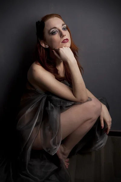 Redhead girl in a dress of black transparent fabric — Stock Photo, Image