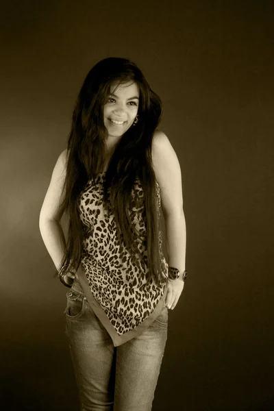 A very beautiful brunette girl in leopard tunic posing in studio — Stock Photo, Image