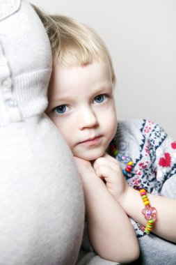 Young girl cuddled up to her mother clipart