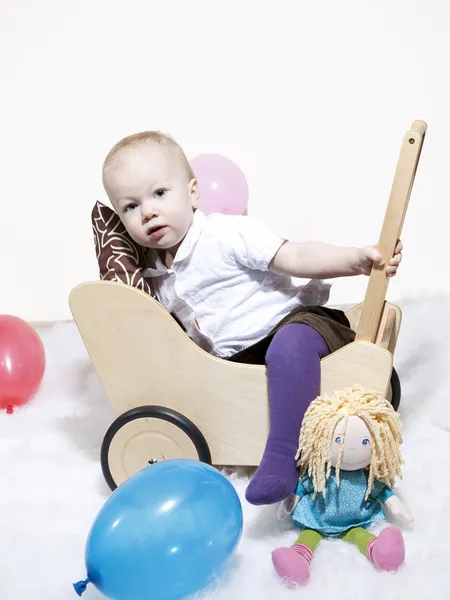 Baby klettert in Puppenwagen — Stockfoto