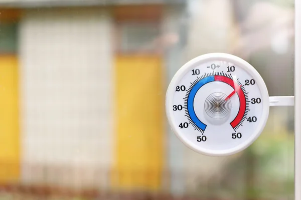 Outdoor thermometer behind the window — Stock Photo, Image
