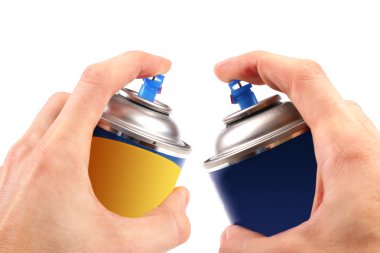 Two graffiti color spray cans in hands clipart