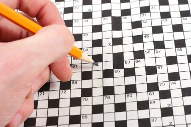 Hand doing crossword