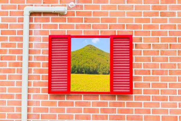 Red window with mountain view — Stock Photo, Image