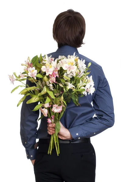 stock image Man hold bouquet of flowers behind his back. isolated on white