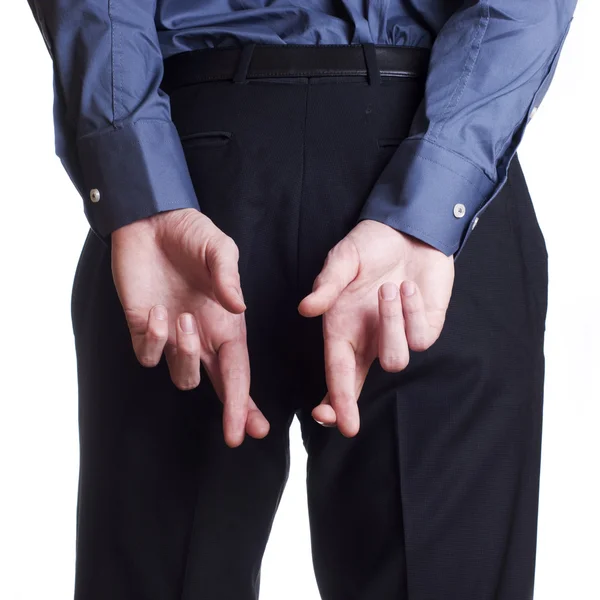 Muž drží a skrýt na zádech přes prsty — Stock fotografie