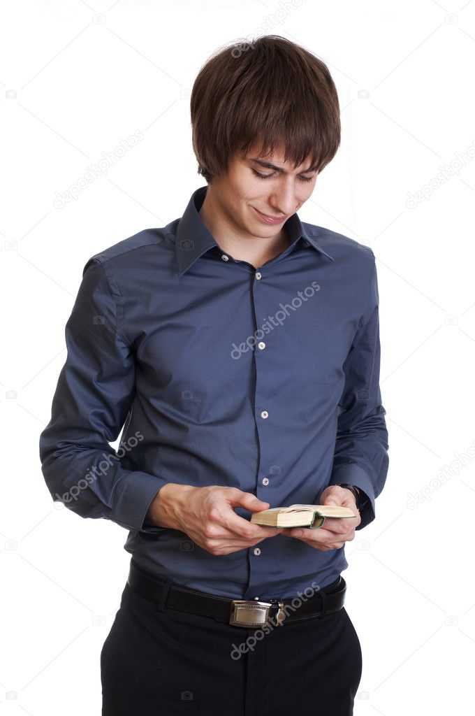 Happy young businessman read something in small book. isolated o