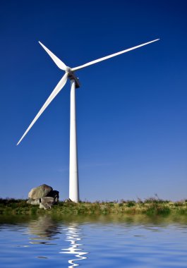 White wind turbine in the top of the mountain clipart