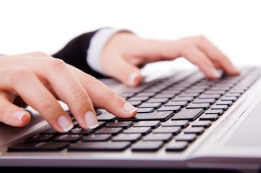 Close up of secretarys hand touching computer keys during work clipart