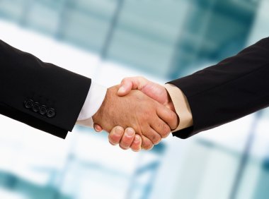 Closeup picture of businesspeople shaking hands, making an agree clipart